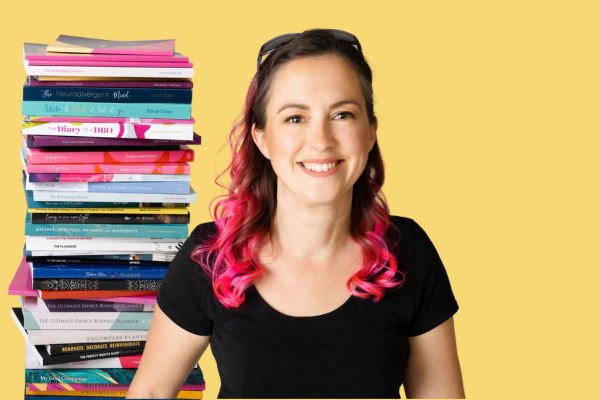 stack of planners and books with Claire smiling